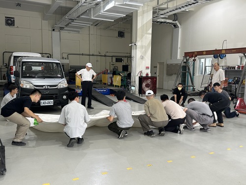 Everyone worked together to store the fire blankets.(Open new window/jpg file)Image